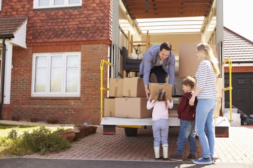Movers navigating a residential street during house removals in Brent