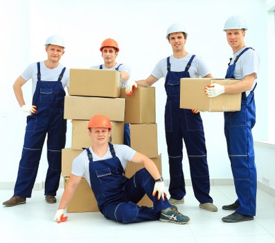 Professional movers loading furniture for a Brent move